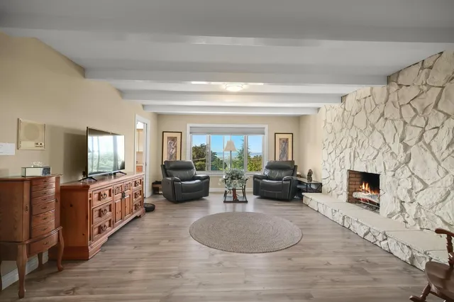 a living room with furniture fireplace and flat screen tv