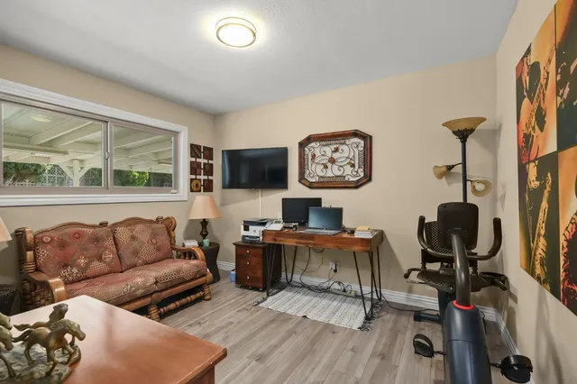 a living room with furniture a rug and a flat screen tv