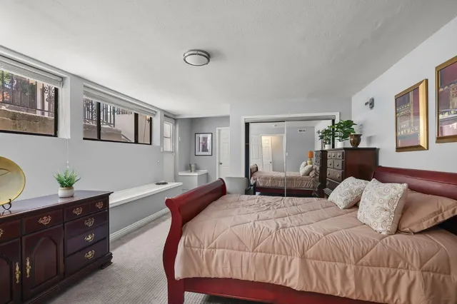 a bedroom with a bed and a dresser