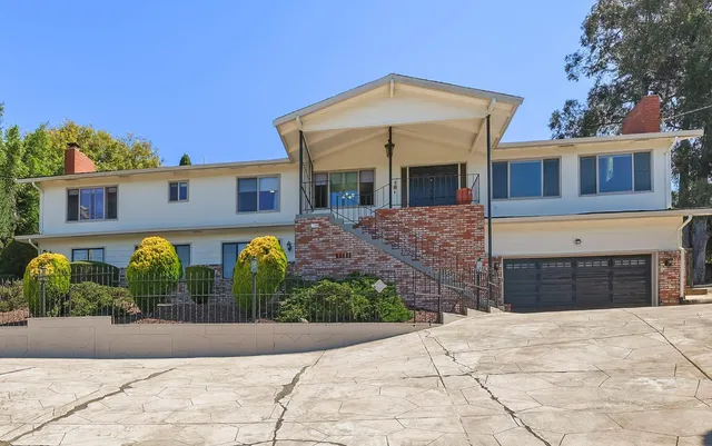 a front view of a house with garden