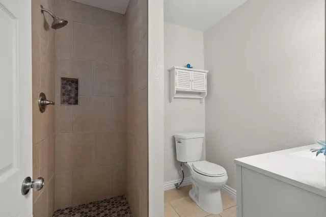 a white toilet sitting next to a bathroom sink