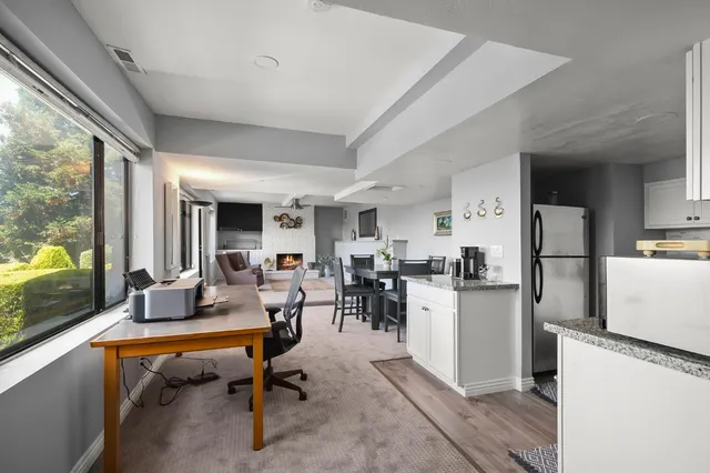 a living room with stainless steel appliances kitchen island granite countertop furniture and a view of kitchen