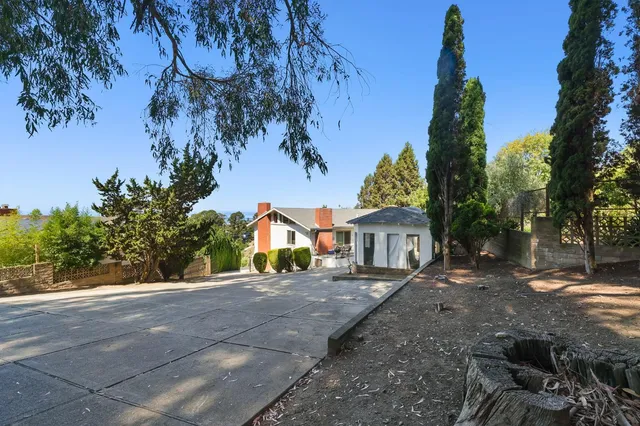 a view of house with outdoor space and trees