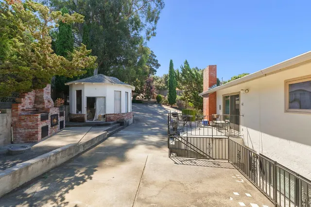 a view of a house with backyard and sitting area