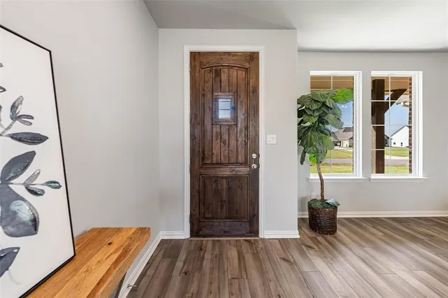 a view of a room that has a window and wooden floor