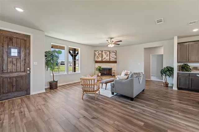 a living room with furniture and wooden floor