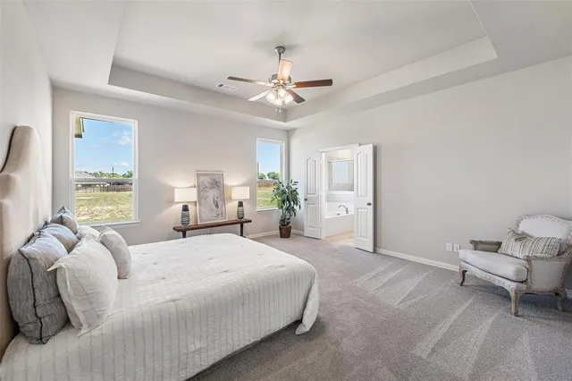 a spacious bedroom with a bed and window