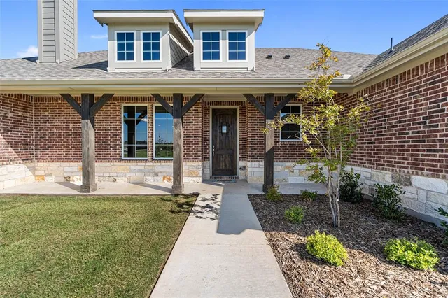 a front view of a building with a garden
