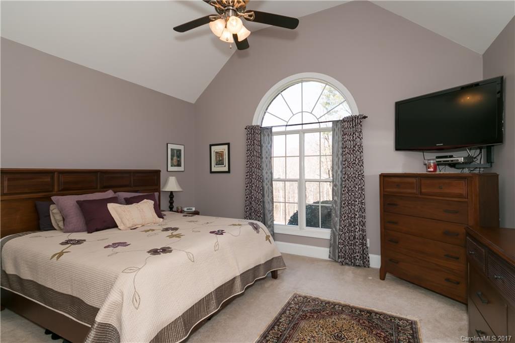 223 Beaten Path Road Mooresville, NC 28117 - Photo 11 of 24 a bedroom with a bed and a flat screen tv