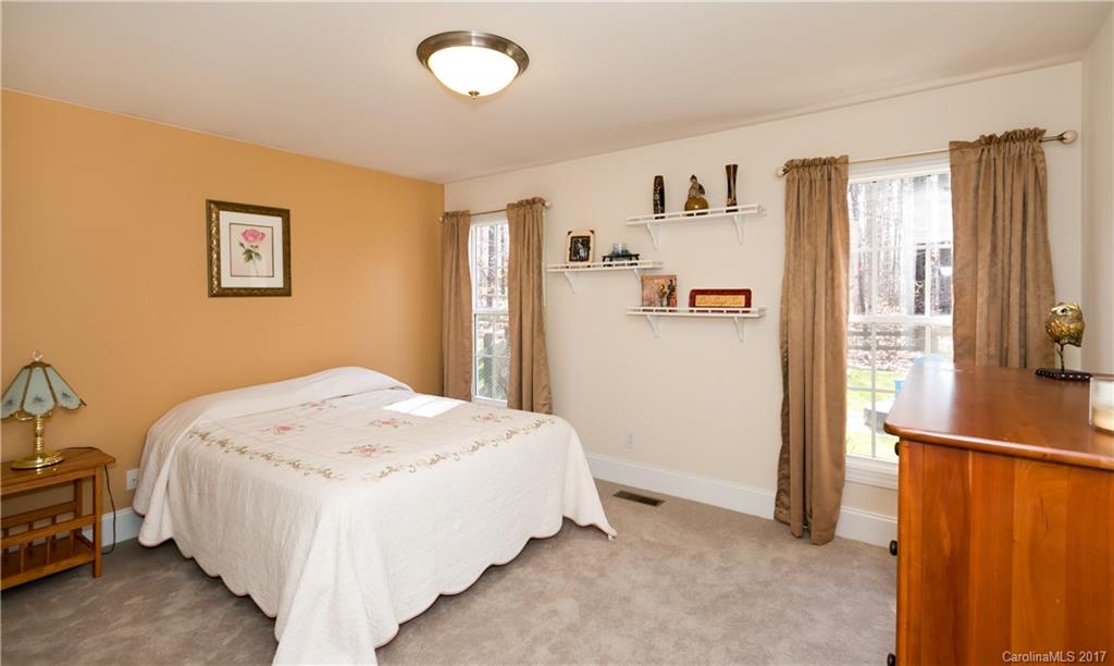 223 Beaten Path Road Mooresville, NC 28117 - Photo 13 of 24 a bedroom with a bed and a refrigerator