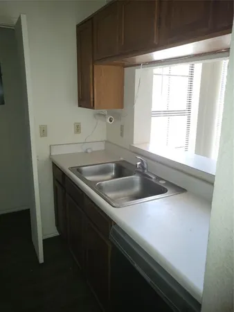 a kitchen with a sink and a window