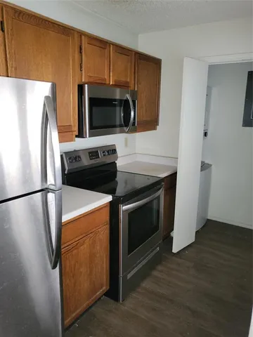 a kitchen with a refrigerator stove and microwave