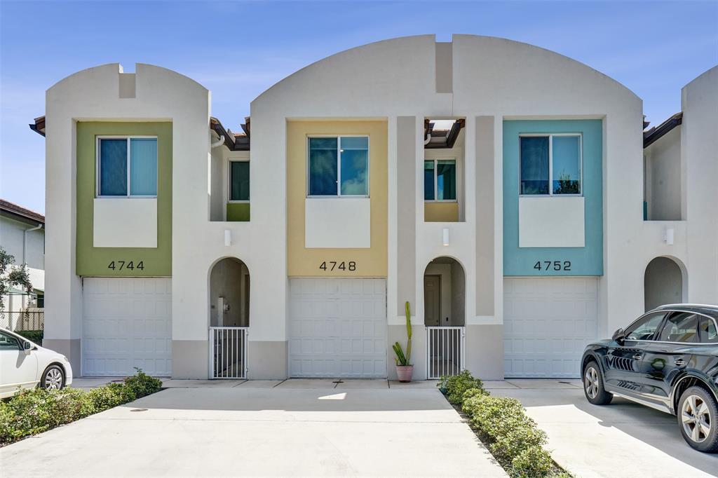 4748 Southwest 63rd Terrace, Unit 4748 Davie, FL 33314 - Photo 1 of 31 a front view of a house with parking
