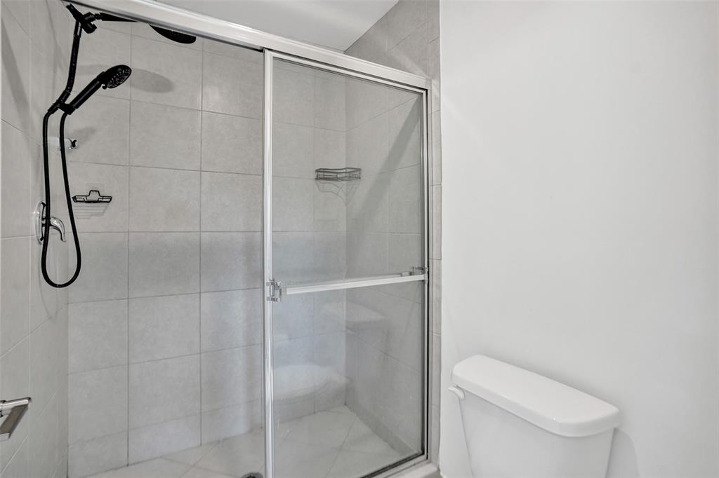 4748 Southwest 63rd Terrace, Unit 4748 Davie, FL 33314 - Photo 17 of 31 a bathroom with a shower and toilet