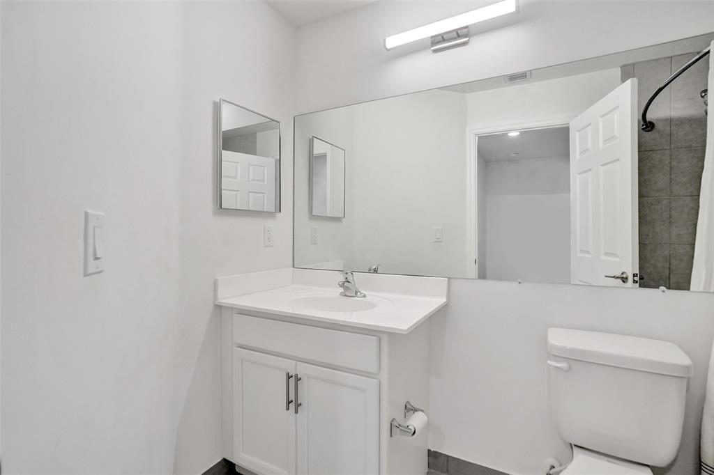 4748 Southwest 63rd Terrace, Unit 4748 Davie, FL 33314 - Photo 18 of 31 a bathroom with a sink toilet and mirror