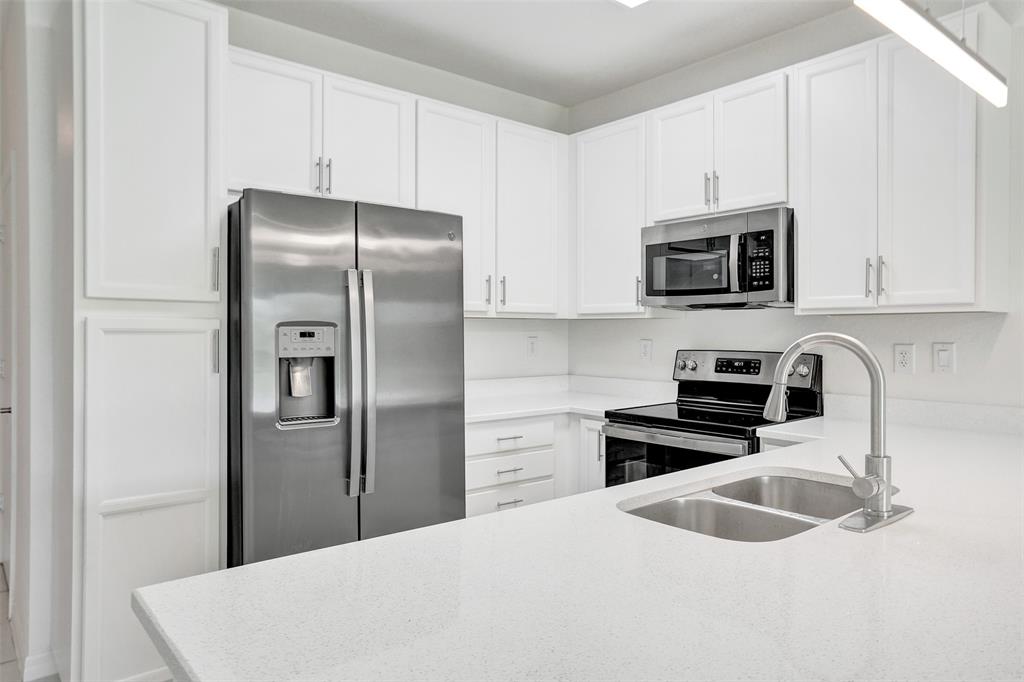 4748 Southwest 63rd Terrace, Unit 4748 Davie, FL 33314 - Photo 4 of 31 a kitchen with stainless steel appliances granite countertop a refrigerator stove a sink and microwave