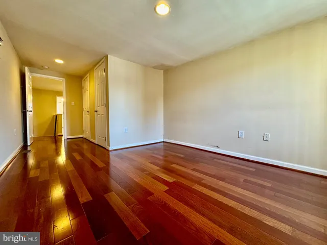 a view of an empty room and wooden floor