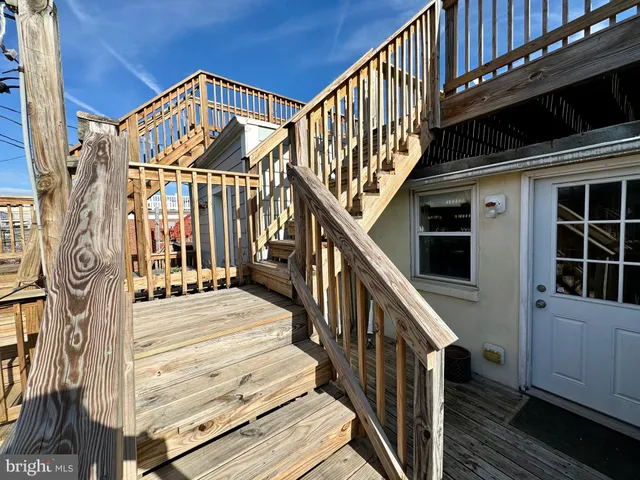 a view of entryway with wooden floor and stairs