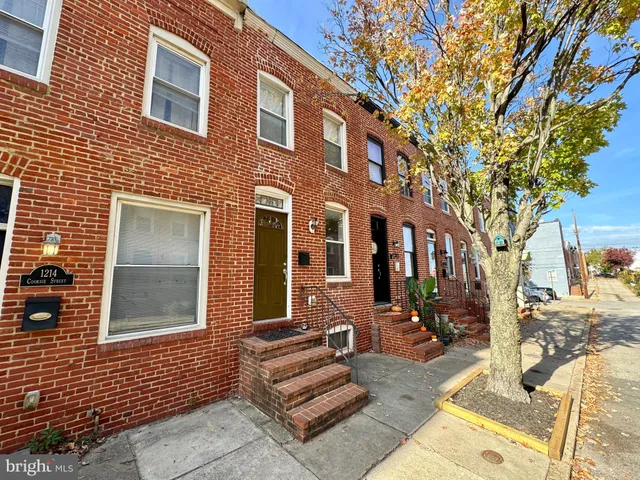a view of a brick building with many windows