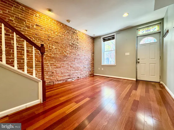 a view of an empty room and wooden floor