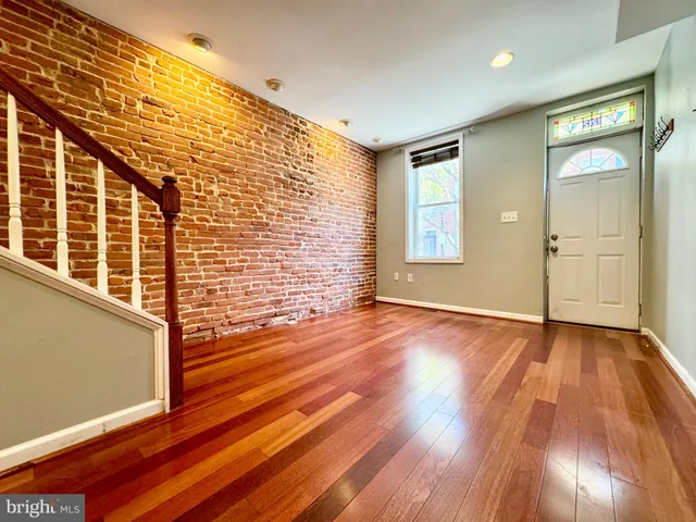 a view of an empty room and wooden floor