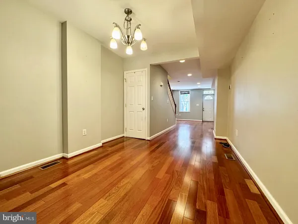 a view of an empty room and wooden floor