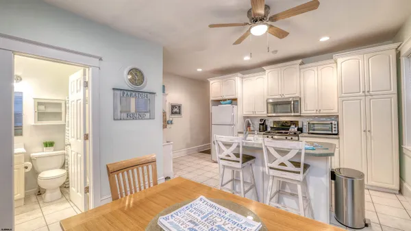 a view of a kitchen with dining room and wooden floor