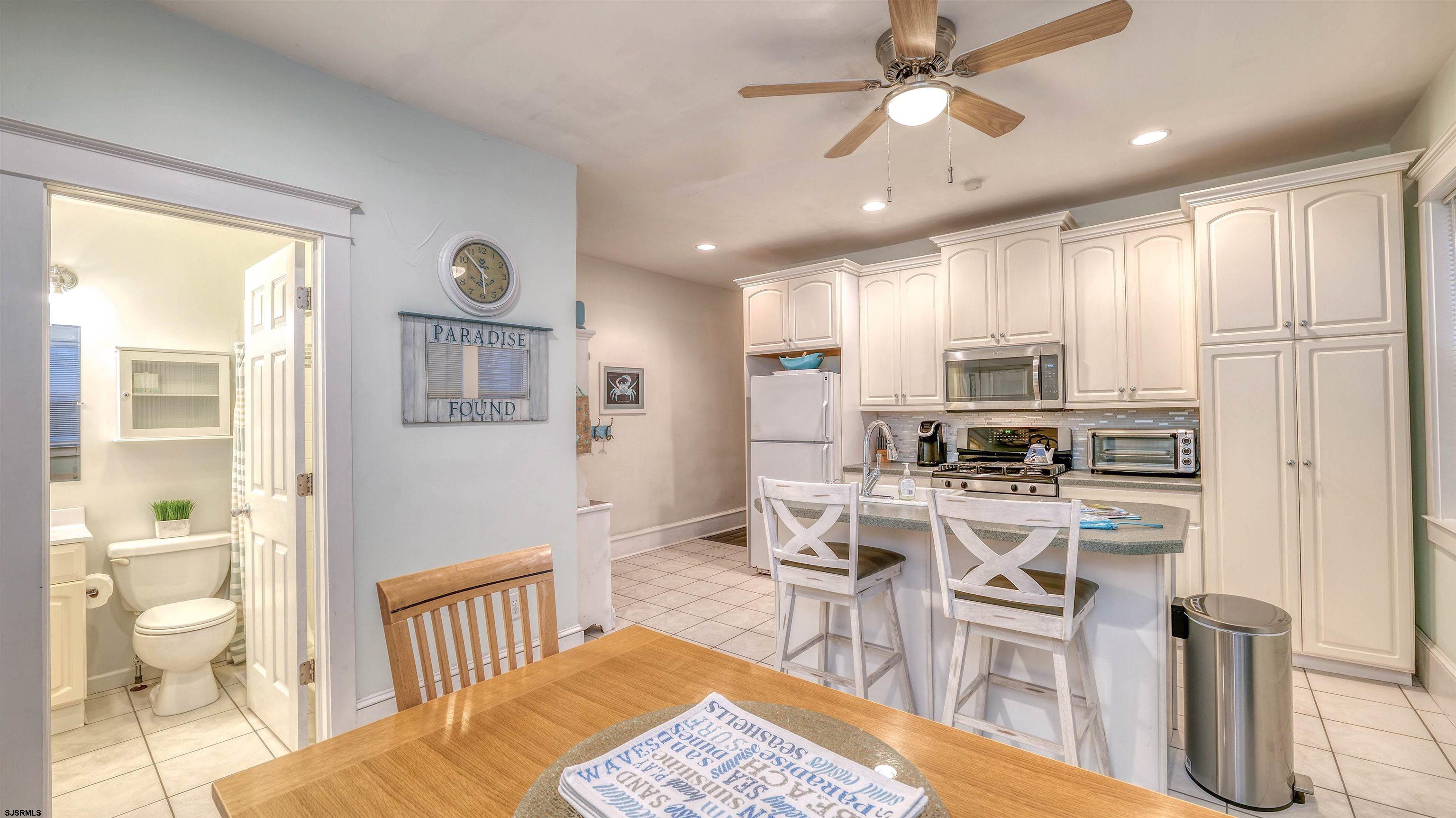 1102 Wesley Avenue, Unit 1 Ocean City, NJ 08226 - Photo 16 of 19 a view of a kitchen with dining room and wooden floor