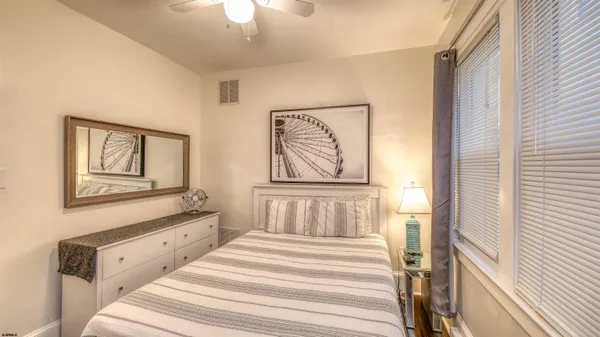 a bedroom with a bed and a painting on the wall