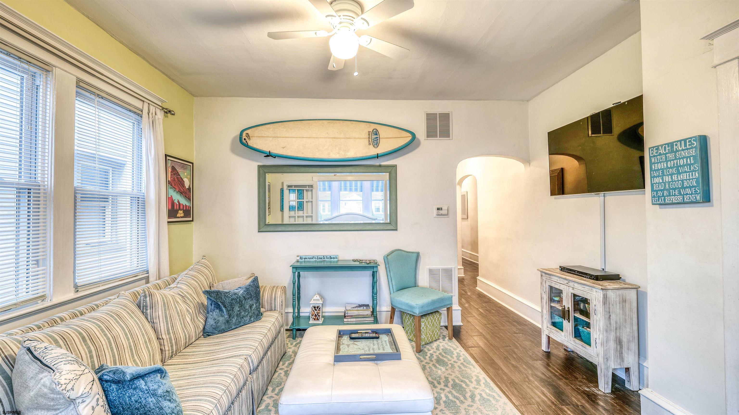 1102 Wesley Avenue, Unit 1 Ocean City, NJ 08226 - Photo 4 of 19 a living room with furniture a rug and a flat screen tv