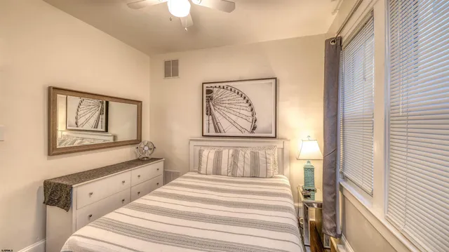 a bedroom with a bed and a painting on the wall