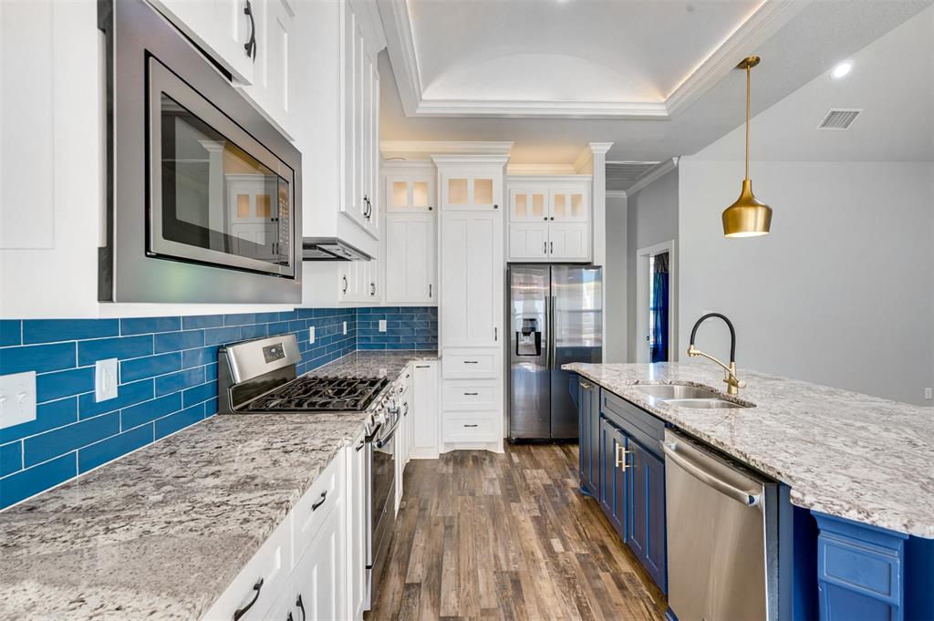 2830 Juniper Lane Tyler, TX 75701 - Photo 12 of 34 a kitchen with stainless steel appliances granite countertop a sink stove and cabinets