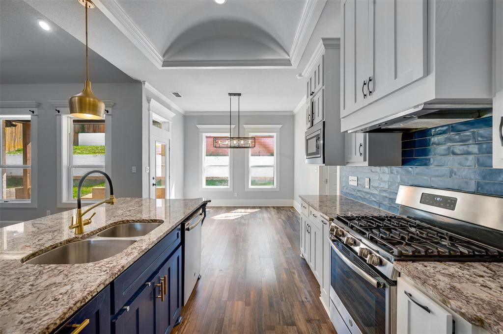 2830 Juniper Lane Tyler, TX 75701 - Photo 13 of 34 a kitchen with granite countertop a sink stove and cabinets
