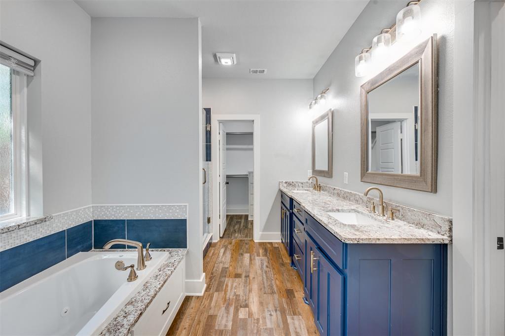 2830 Juniper Lane Tyler, TX 75701 - Photo 19 of 34 a spacious bathroom with a tub double vanity sink and a mirror