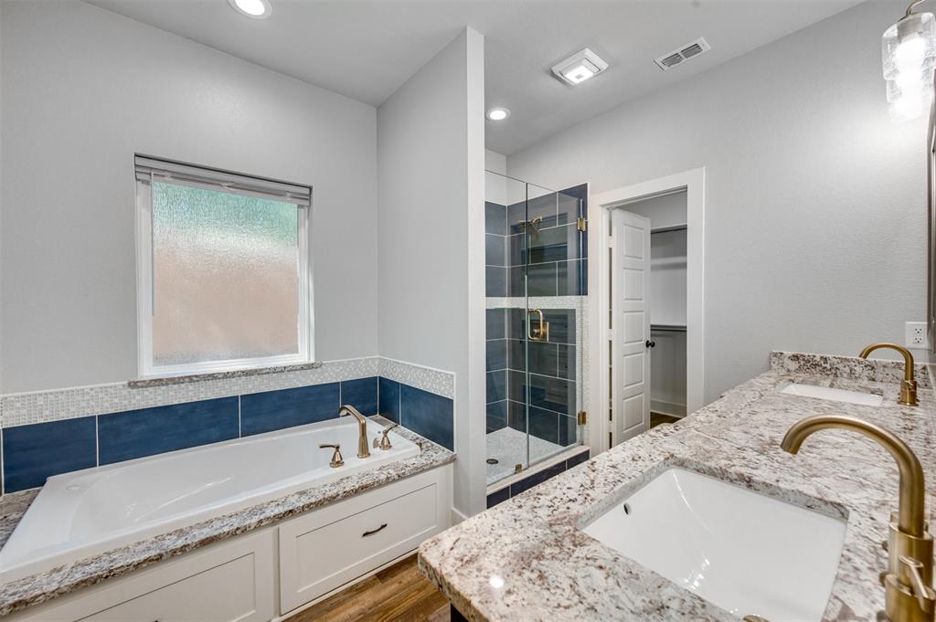 2830 Juniper Lane Tyler, TX 75701 - Photo 20 of 34 a bathroom with a tub sink and mirror