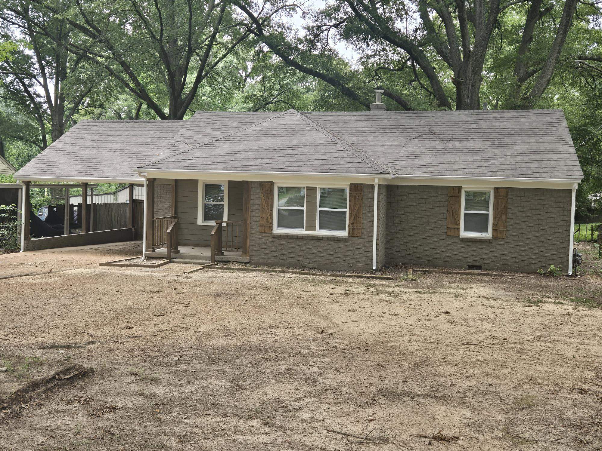 View of front of house featuring brick siding, a shingled roof, and crawl space
