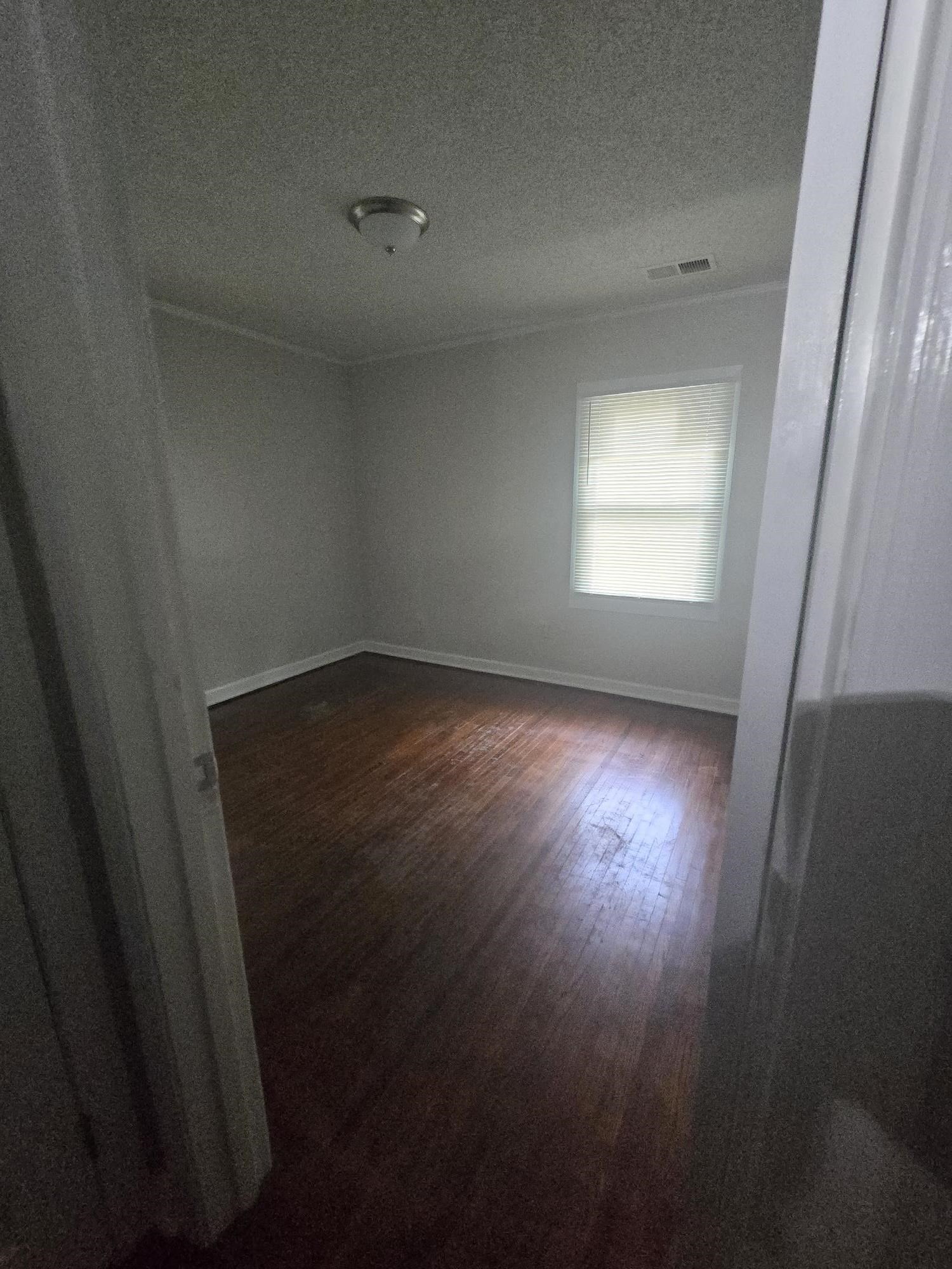 3551 Millington Road Memphis, TN 38127 - Photo 9 of 12 Empty room with dark wood-style floors and a textured ceiling