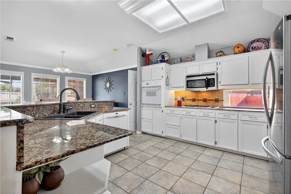 a very nice looking kitchen with white cabinets