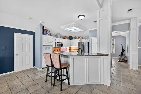 a kitchen with stainless steel appliances kitchen island granite countertop a sink and cabinets