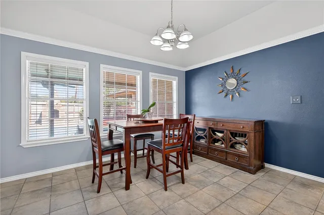 a view of a dining room with furniture and chandelier