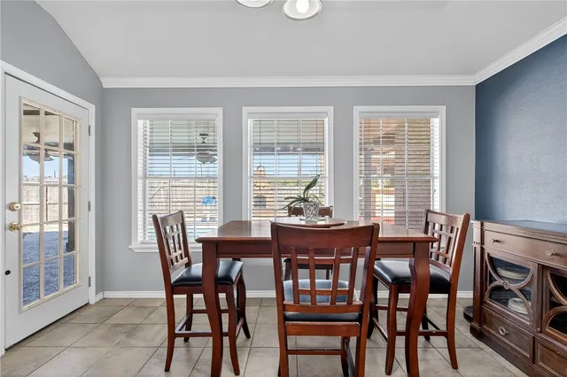 a view of a dining room with furniture and windows