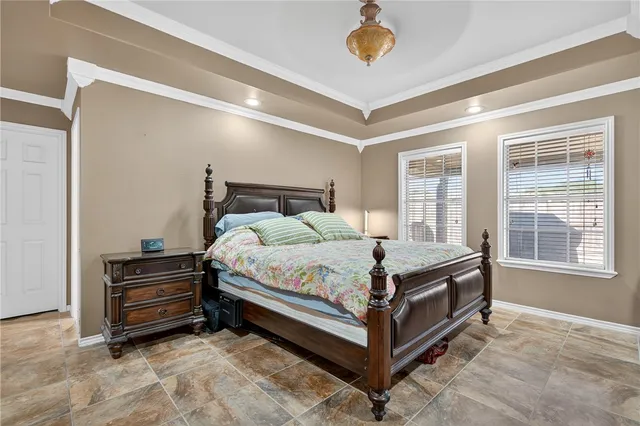 a bed sitting in a bedroom next to a window