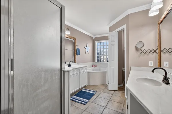 a room with a sink a mirror and a shower