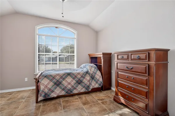 a bedroom with a bed and a dresser