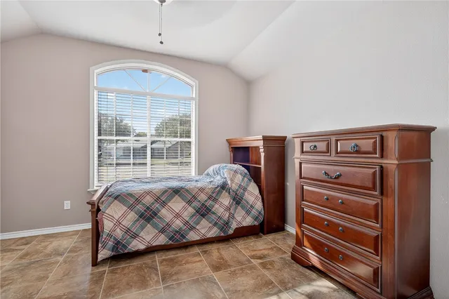 a bedroom with a bed and a dresser