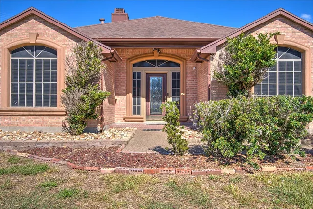 a front view of a house with garden
