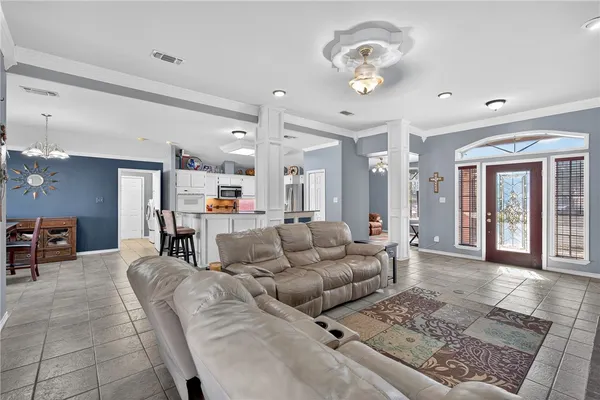 a living room with furniture and a chandelier