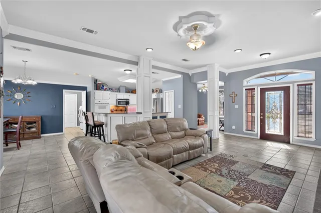 a living room with furniture and a chandelier