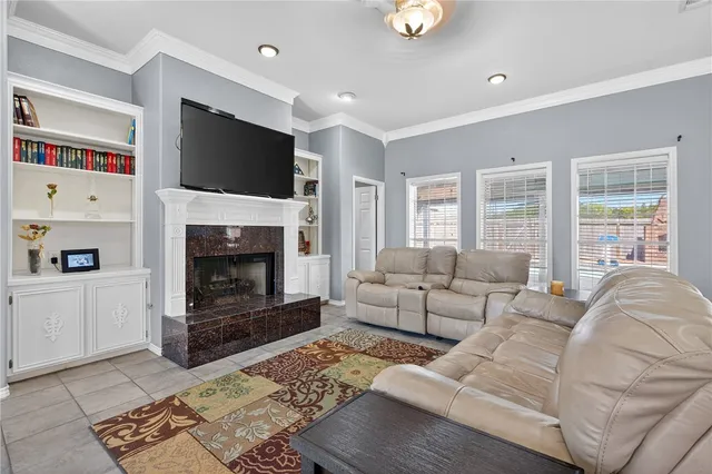 a living room with furniture a flat screen tv and a fireplace
