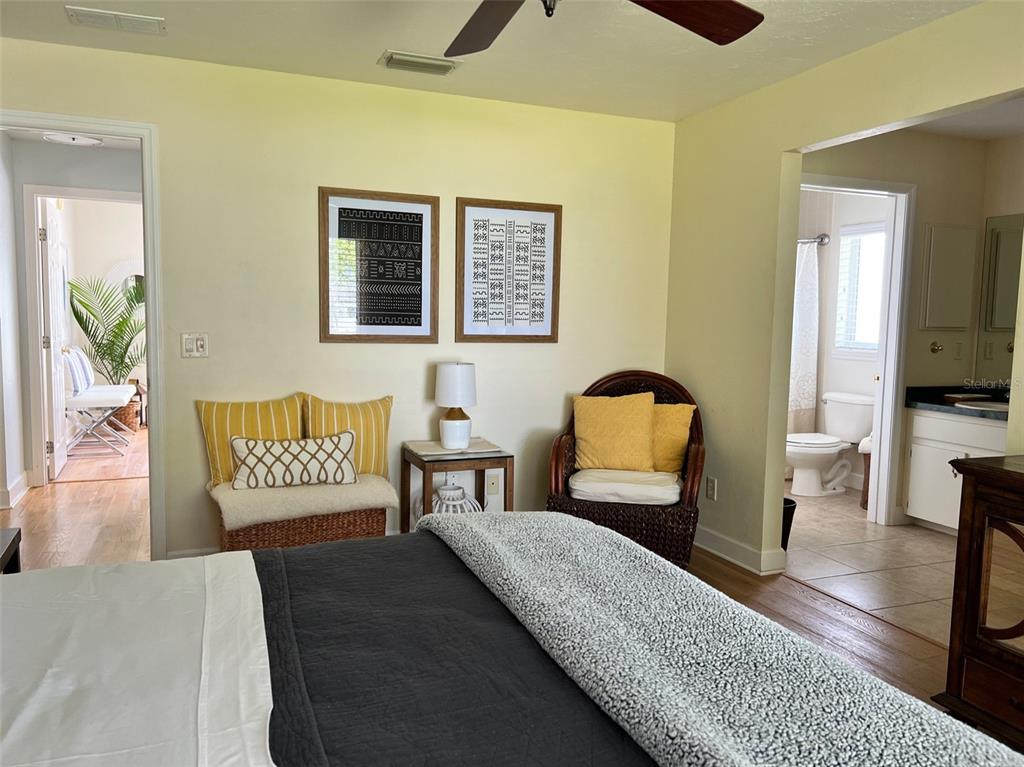 12595 Southeast Sunset Harbor Road Weirsdale, FL 32195 - Photo 13 of 25 a bedroom with a bed and wooden floor